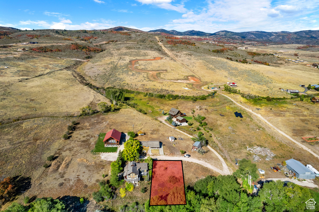 Aerial overview of property's location featuring a mountain backdrop and rural landscape