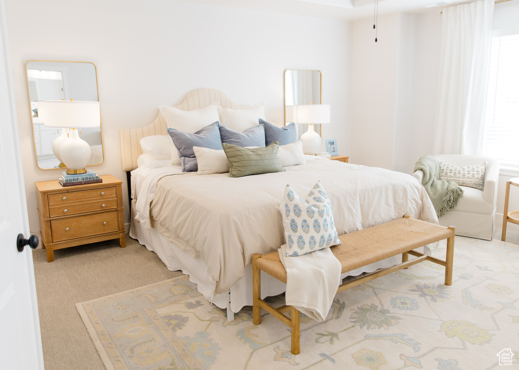 Bedroom featuring light carpet