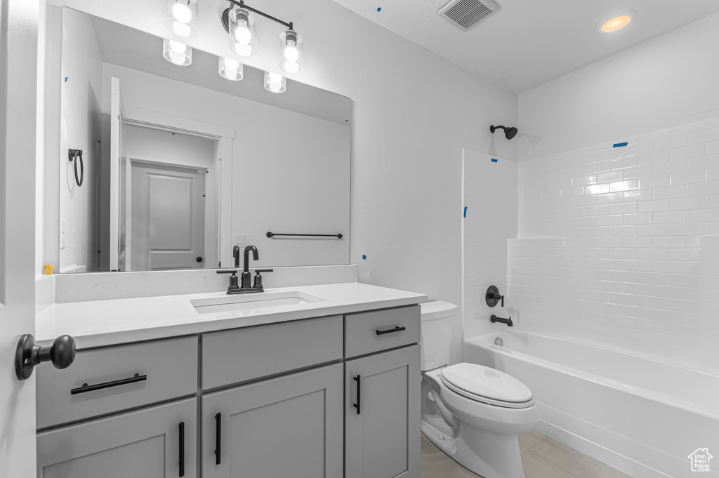 Full bath with toilet, vanity, shower / tub combination, and tile patterned flooring