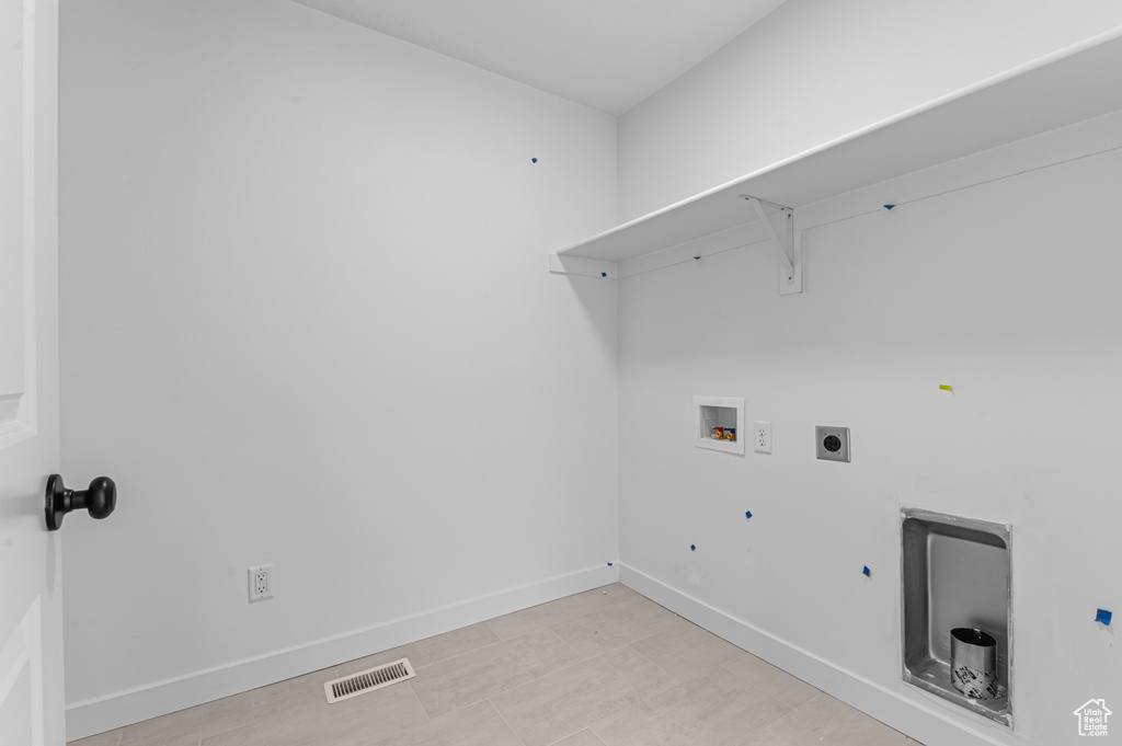 Laundry area featuring electric dryer hookup, washer hookup, hookup for a gas dryer, and baseboards