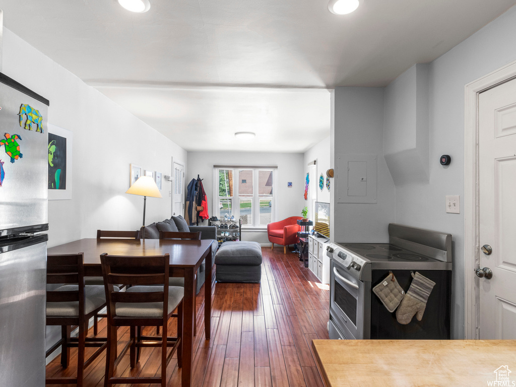 Kitchen featuring appliances with stainless steel finishes, dark wood-type flooring, and recessed lighting