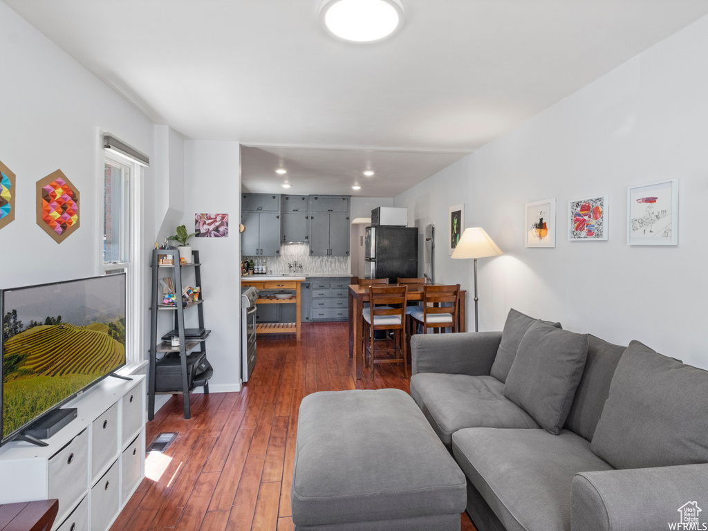 Living room featuring dark wood finished floors and recessed lighting