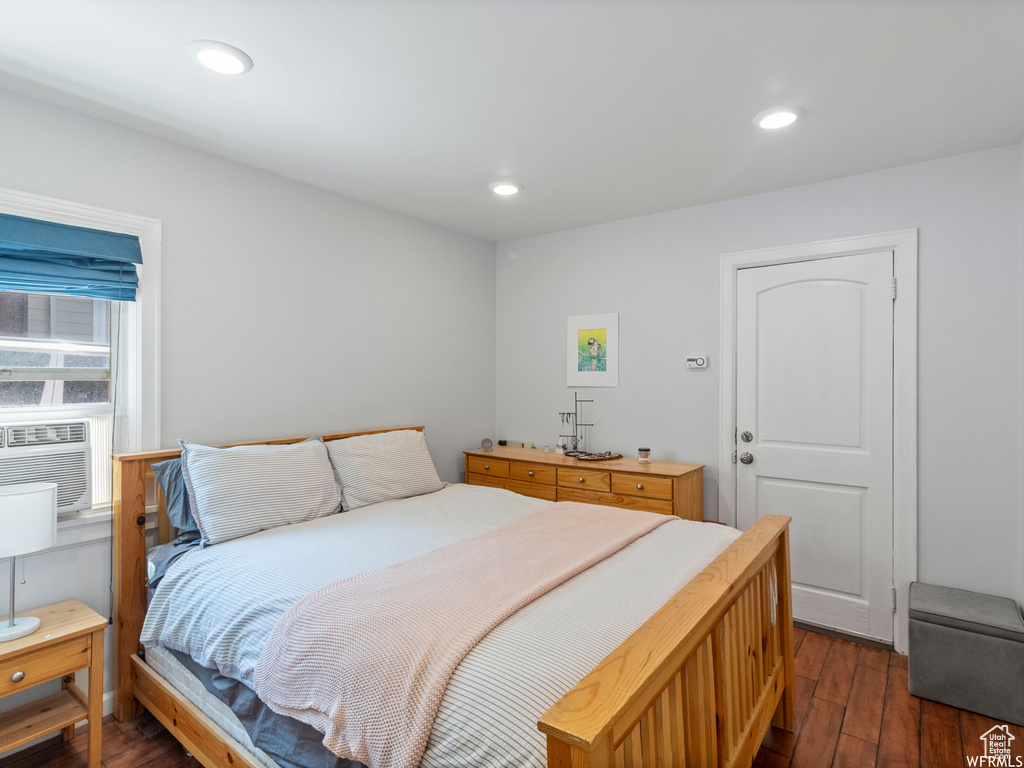 Bedroom featuring dark wood-style floors, cooling unit, and recessed lighting