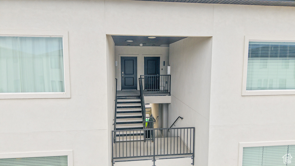 Entrance to property featuring stucco siding