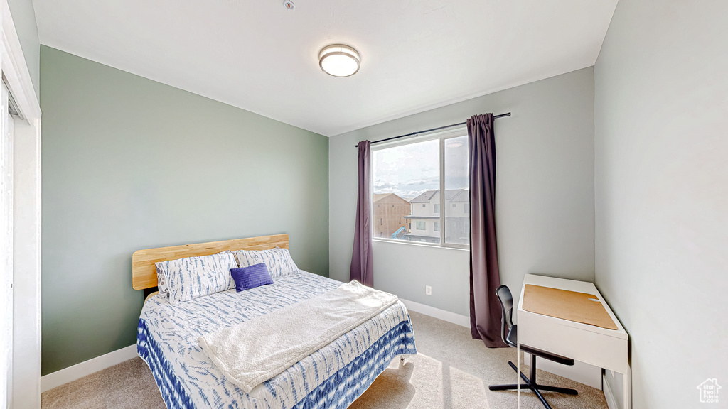 Carpeted bedroom featuring baseboards