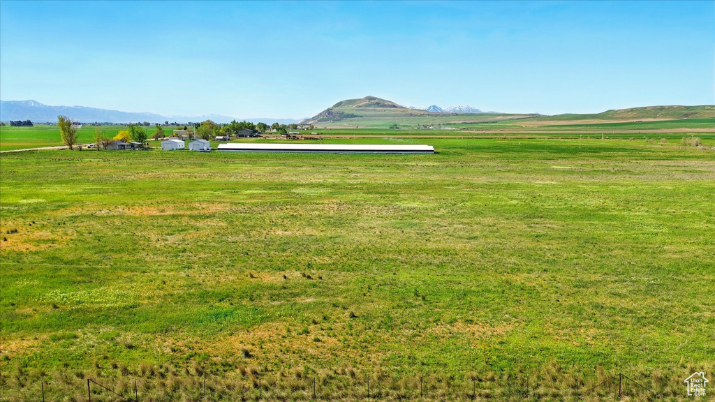 View of home's community with a view of rural / pastoral area, a mountain view, and a lawn