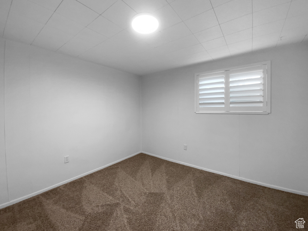 Spare room featuring carpet floors and baseboards