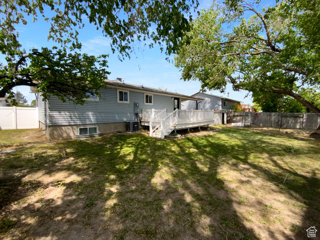 Back of house with a wooden deck, cooling unit, and stairway