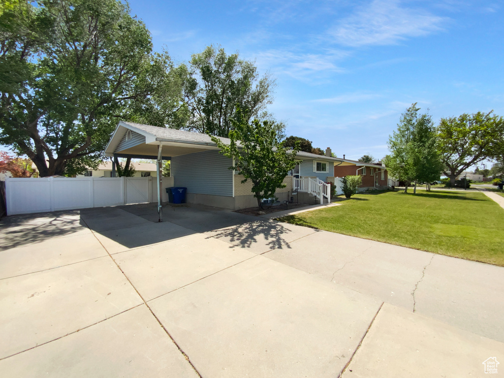 View of front of house featuring driveway and an attached carport