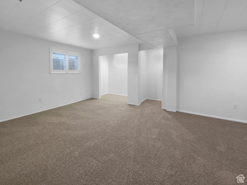 Carpeted empty room with baseboards