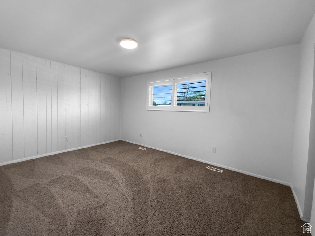 Carpeted empty room with baseboards