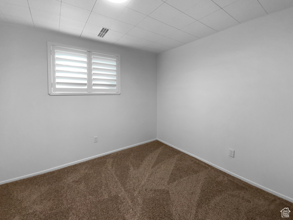 Carpeted spare room with baseboards