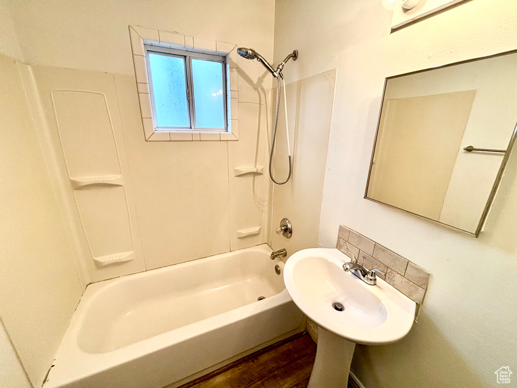 Full bathroom featuring a sink, bathing tub / shower combination, and wood finished floors