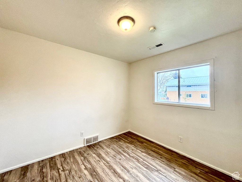 Spare room with wood finished floors and baseboards