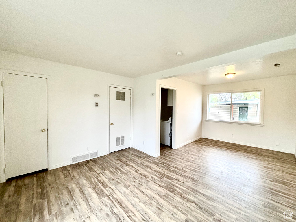 Spare room with wood finished floors and baseboards