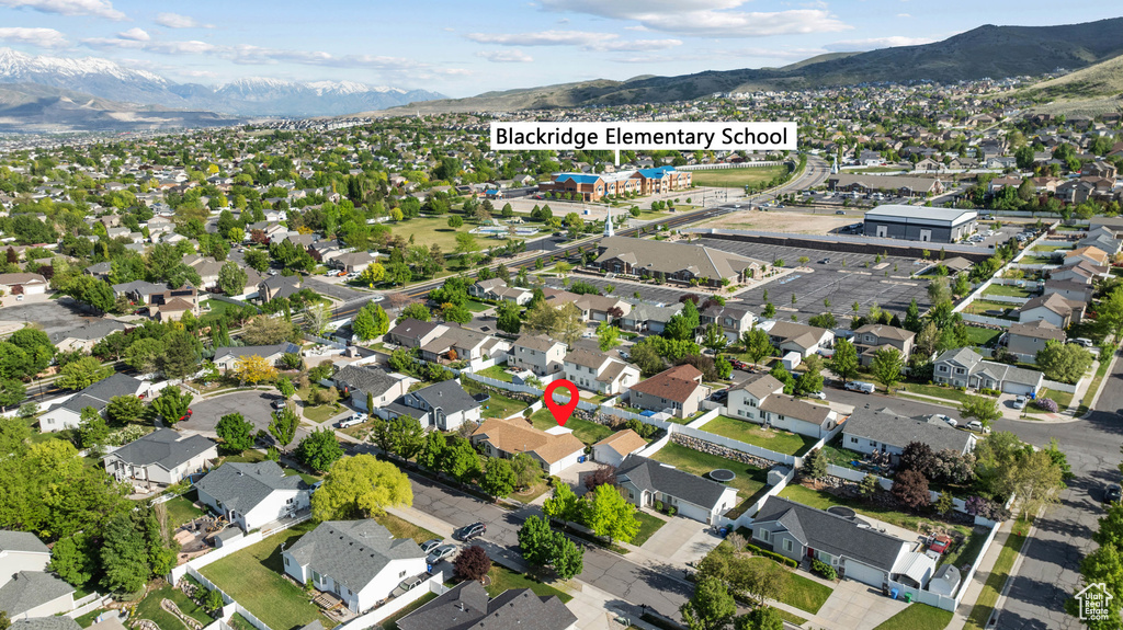 Aerial overview of property\'s location with a mountainous background and nearby suburban area