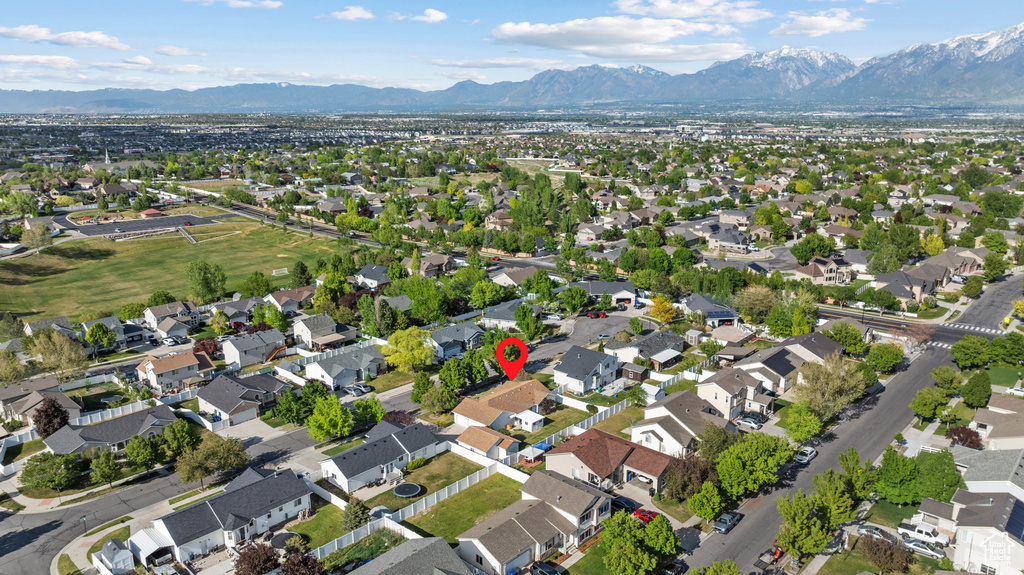 Aerial overview of property\'s location with a mountainous background and nearby suburban area