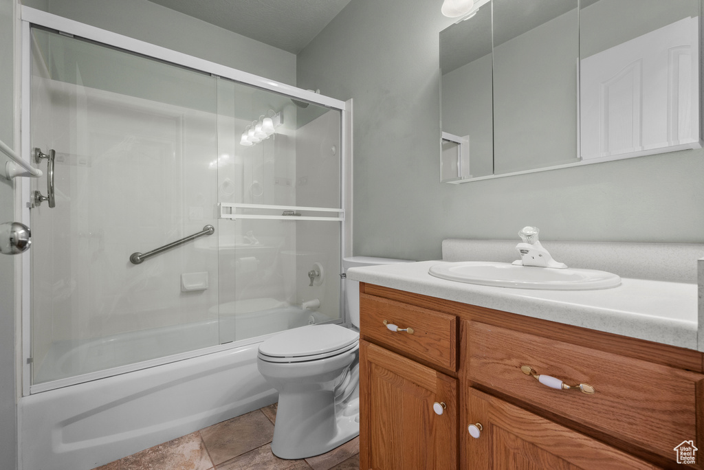 Full bath with toilet, combined bath / shower with glass door, and vanity