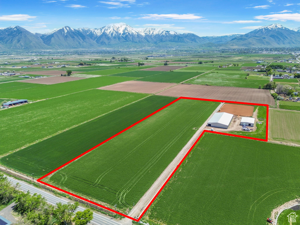 Overview of rural landscape with property parcel outlined and mountains