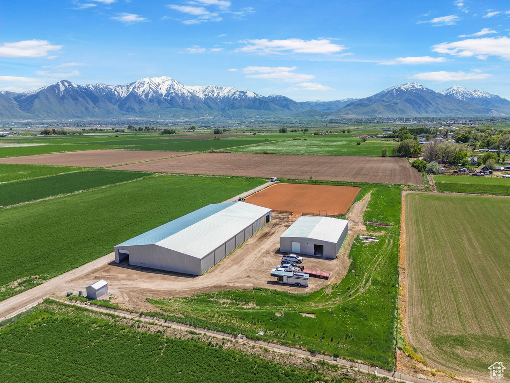 View of rural area featuring a mountain backdrop and rows of crops