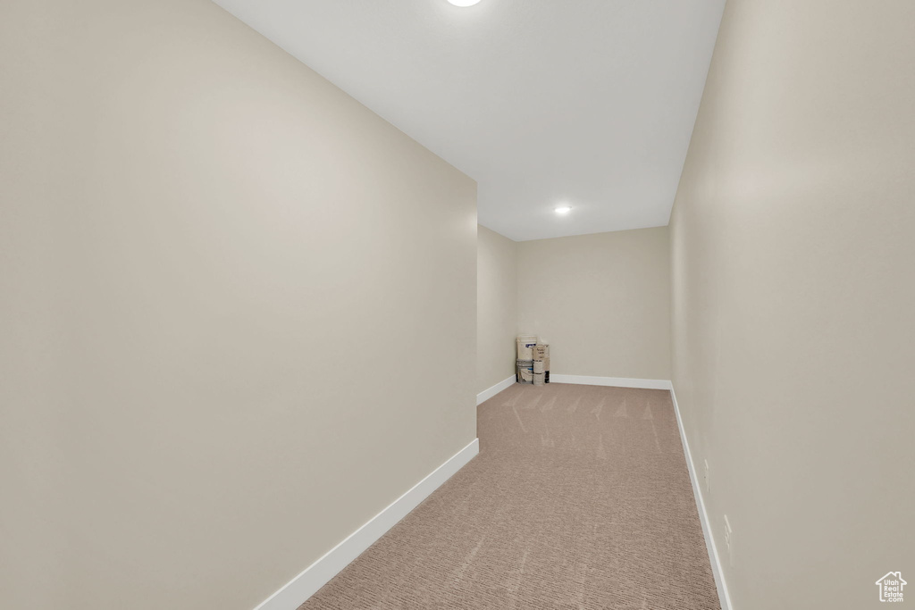Hall with light carpet, baseboards, and recessed lighting