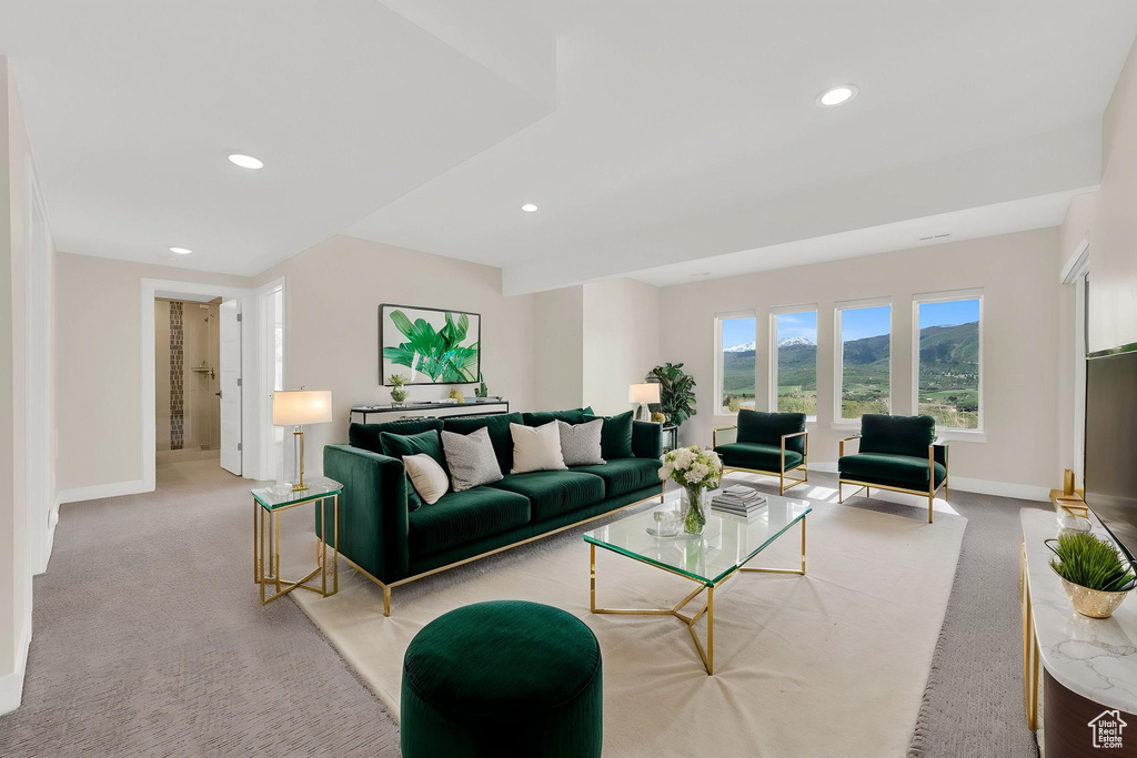 Carpeted living area featuring baseboards and recessed lighting