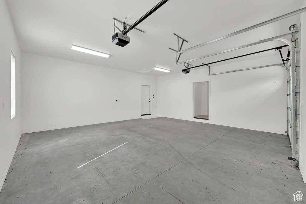 Garage featuring a garage door opener