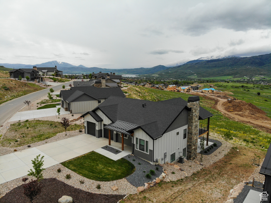 Aerial view of property and surrounding area with a mountainous background