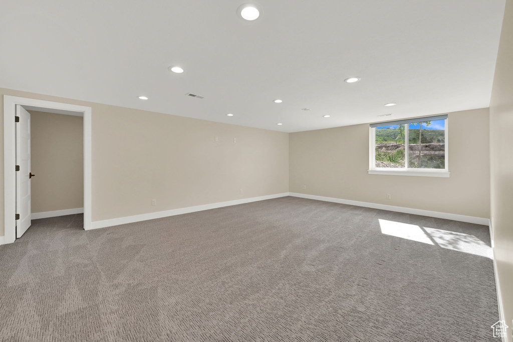 Empty room featuring recessed lighting, carpet, and baseboards