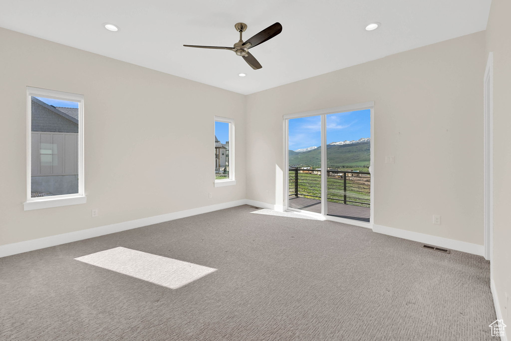 Spare room with carpet flooring, ceiling fan, baseboards, and recessed lighting