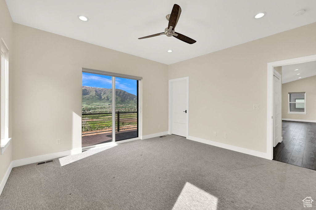 Spare room featuring a ceiling fan, recessed lighting, baseboards, and dark colored carpet