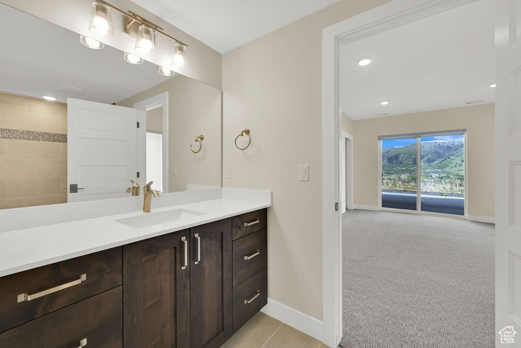Full bathroom featuring baseboards, vanity, and recessed lighting