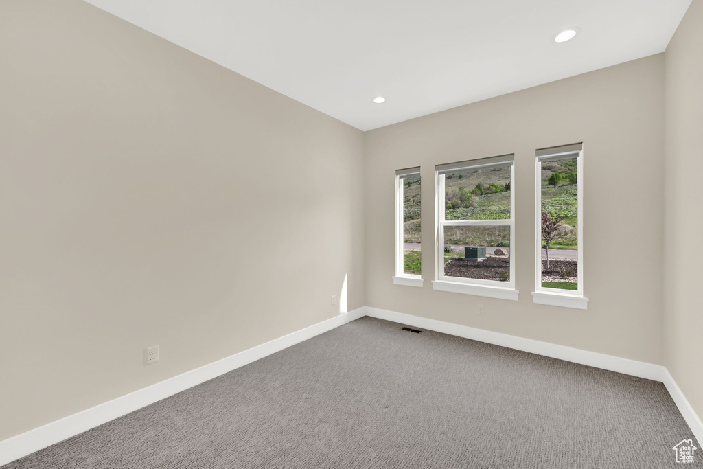 Spare room with baseboards, recessed lighting, and carpet flooring