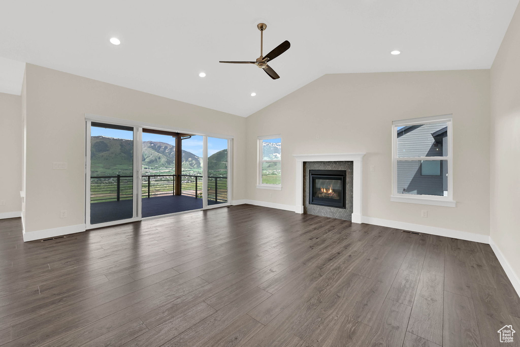 Unfurnished living room with ceiling fan, dark wood-style flooring, a glass covered fireplace, baseboards, and recessed lighting