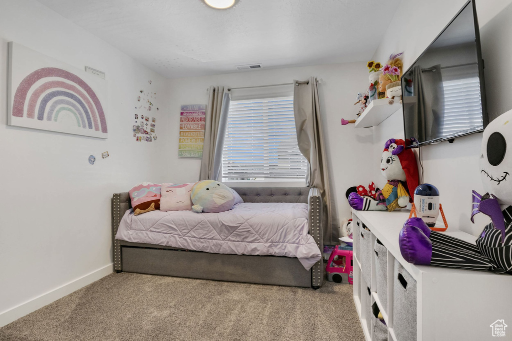 Bedroom featuring carpet floors and baseboards