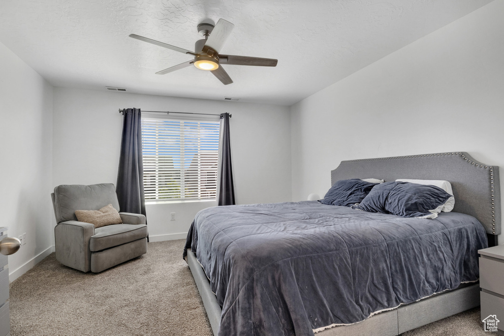 Bedroom featuring carpet flooring, baseboards, and a ceiling fan