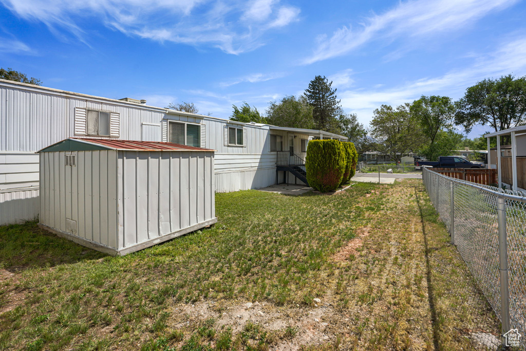 View of yard with a storage unit and an outbuilding