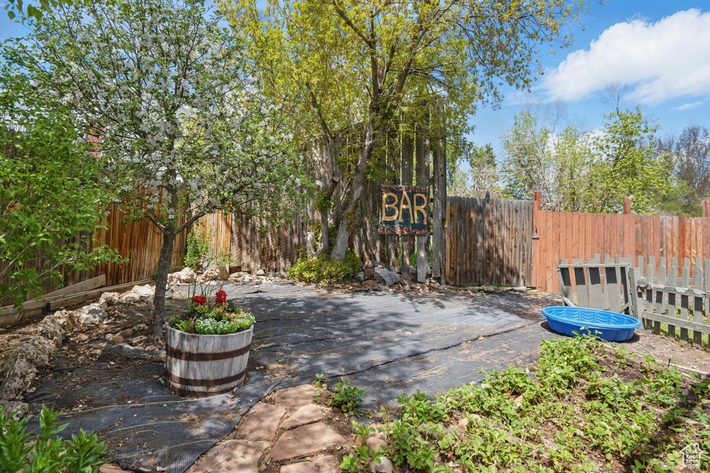 View of patio featuring fence and a gate
