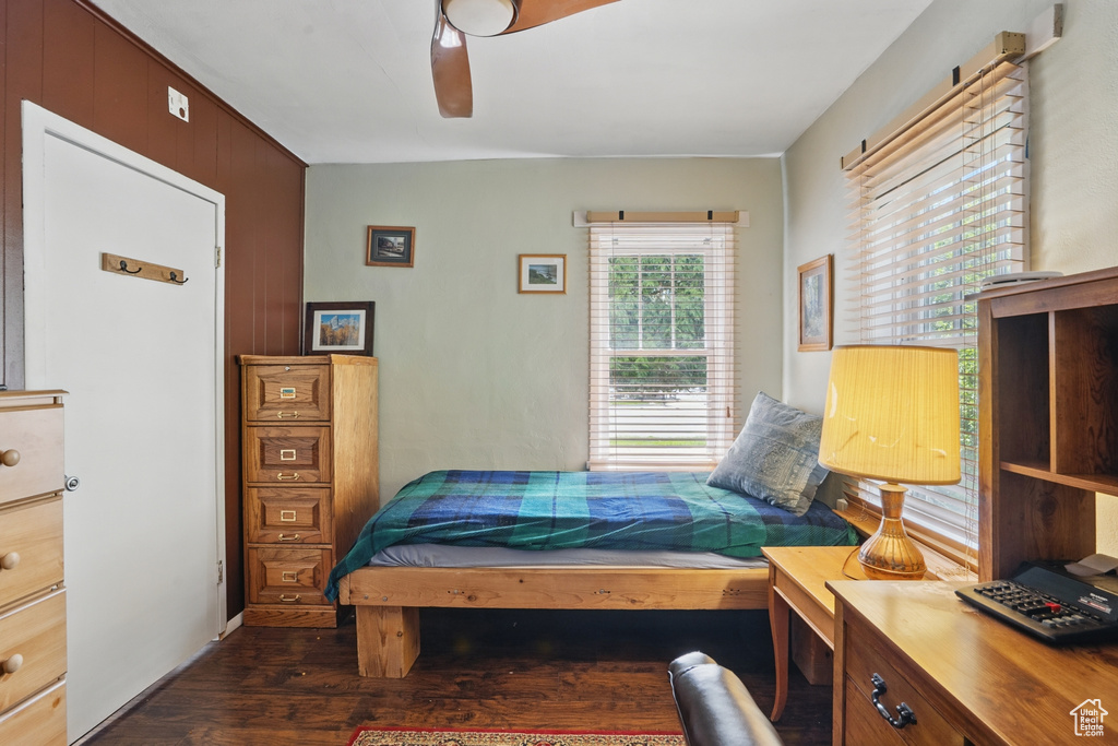 Bedroom with dark wood finished floors and a ceiling fan