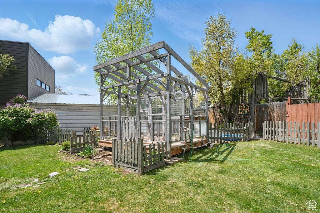 View of yard featuring a greenhouse and an outdoor structure