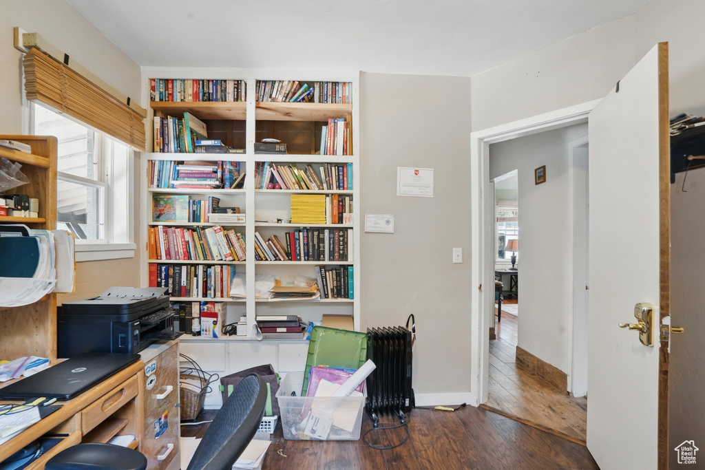 Office featuring healthy amount of natural light, wood-type flooring, and baseboards