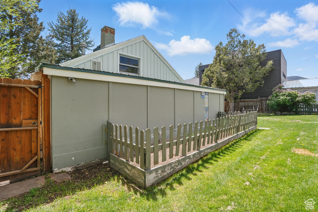 View of property exterior featuring board and batten siding and a chimney