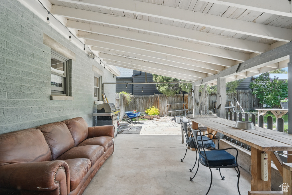 View of patio featuring a fenced backyard, outdoor lounge area, and a grill