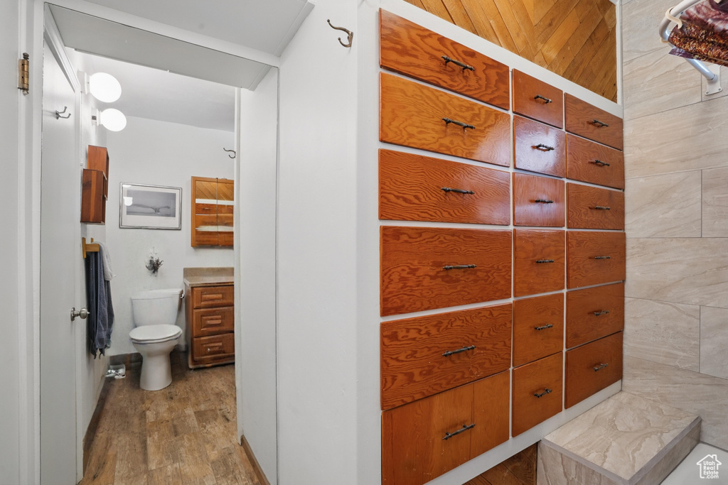 Bathroom with toilet and wood finished floors