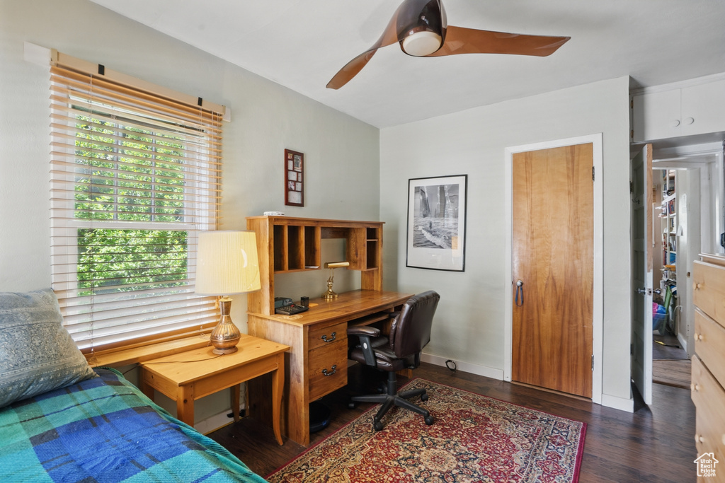 Office area with wood finished floors and ceiling fan