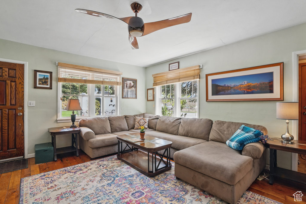 Living room with wood-type flooring, plenty of natural light, and a ceiling fan