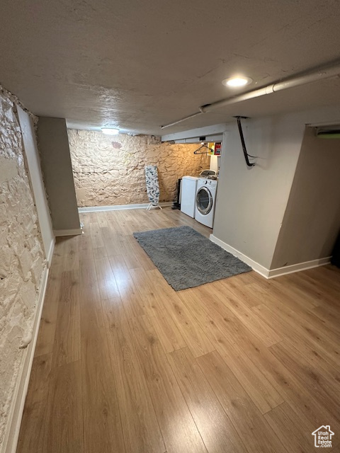 Finished below grade area featuring light wood-type flooring and baseboards