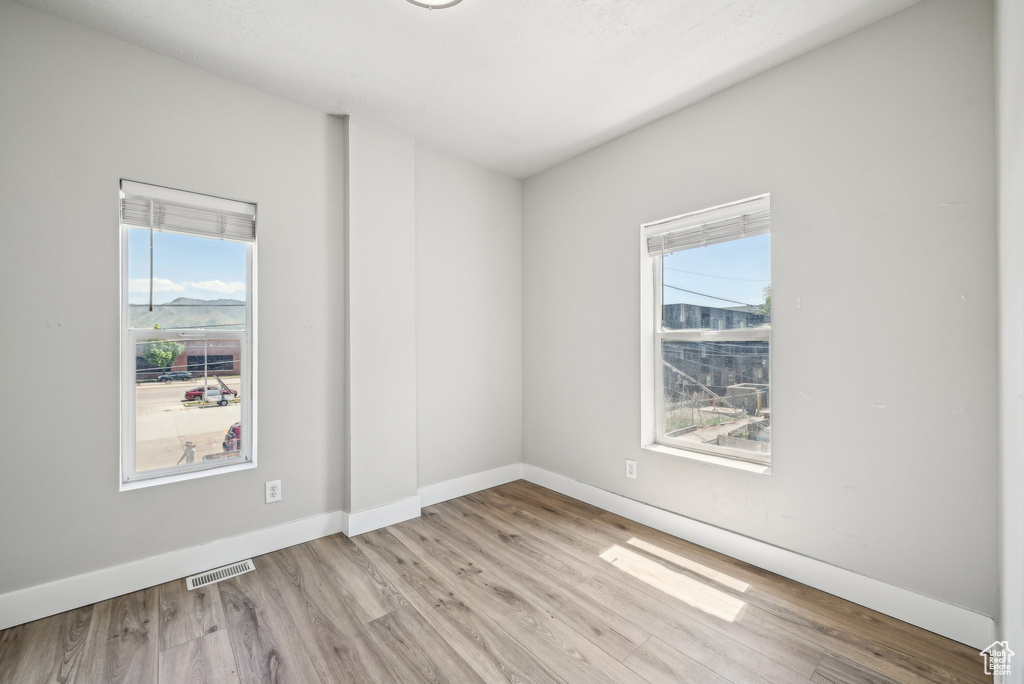 Spare room featuring wood finished floors and baseboards