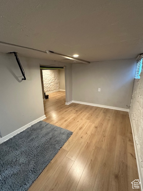 Finished basement featuring light wood-type flooring and baseboards