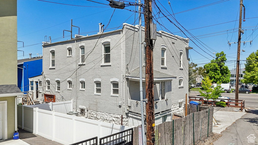 View of front of house featuring fence and brick siding